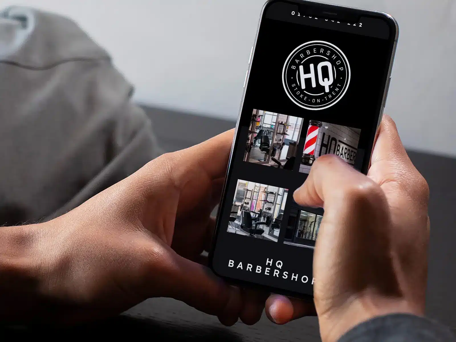 Barbershop website on phone Barbershop website on a phone in hand