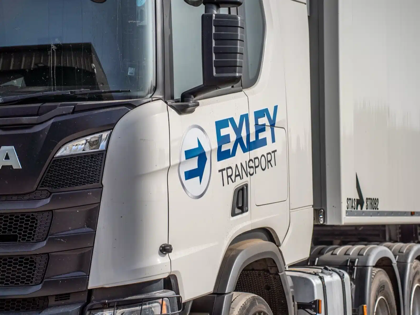 Haulage company logo livery on a Scania cab door