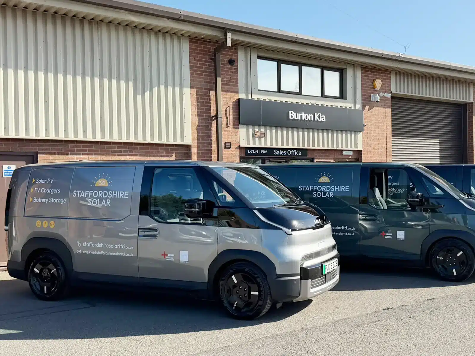 Solar installer vans with new livery outside a dealership